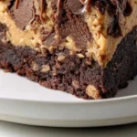 Delicious 1-Bowl Peanut Butter Cup Dump Cake topped with peanut butter cups