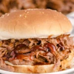 Delicious slow cooker BBQ pulled pork served with coleslaw on a bun