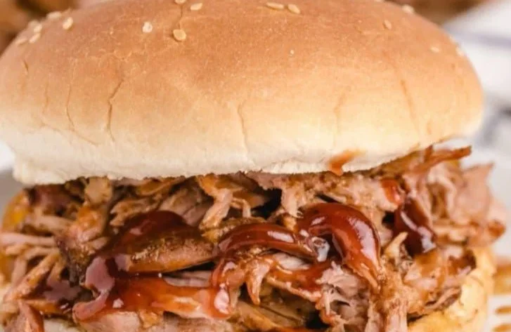 Delicious slow cooker BBQ pulled pork served with coleslaw on a bun