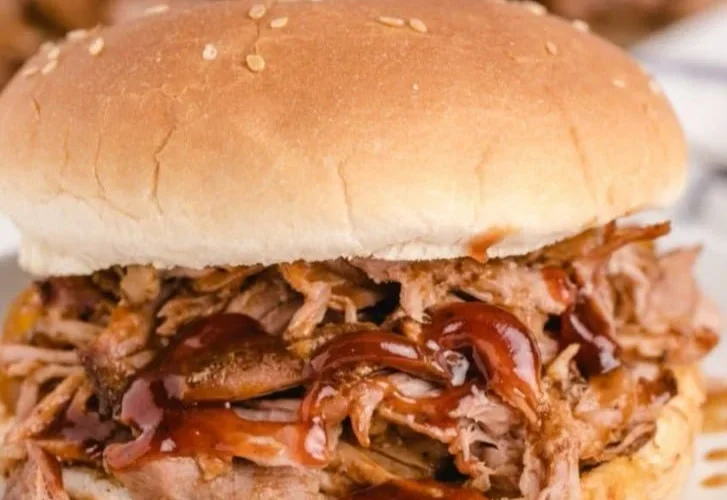 Delicious slow cooker BBQ pulled pork served with coleslaw on a bun