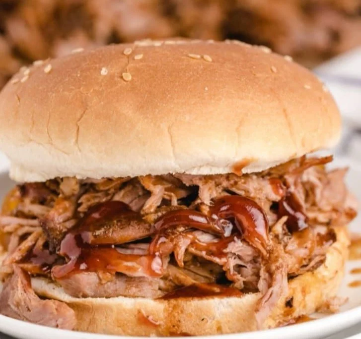 Delicious slow cooker BBQ pulled pork served with coleslaw on a bun