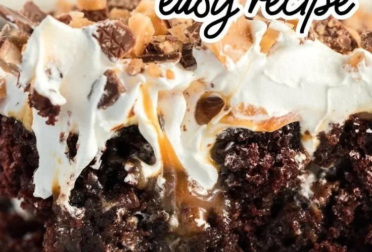 Delicious slice of Better Than Sex Cake topped with whipped cream and chocolate