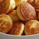 Delicious breakfast pancake poppers served with syrup and berries