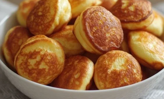 Delicious breakfast pancake poppers served with syrup and berries