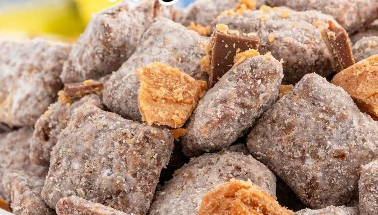 Delicious Butterfinger Puppy Chow made with chocolate and Butterfinger candy