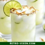 Refreshing Coconut Lime Refresher drink with lime slices and coconut garnish