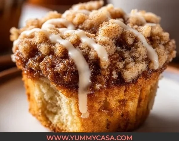 Freshly baked coffee cake muffins on a wooden table.