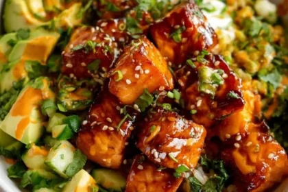 Honey glazed salmon rice bowl with colorful vegetables and rice