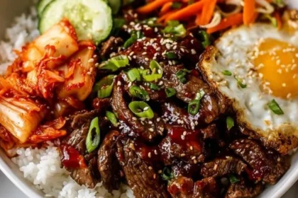 Korean Bulgogi Beef Bowl with tender beef, steamed rice, and kimchi.