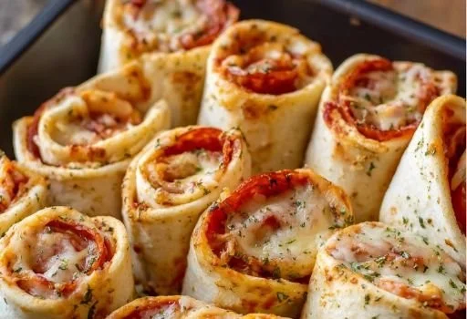 Homemade Pizza Roll-Ups served on a plate with dipping sauce