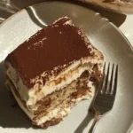 Protein-Packed Tiramisu topped with cocoa powder and coffee beans.