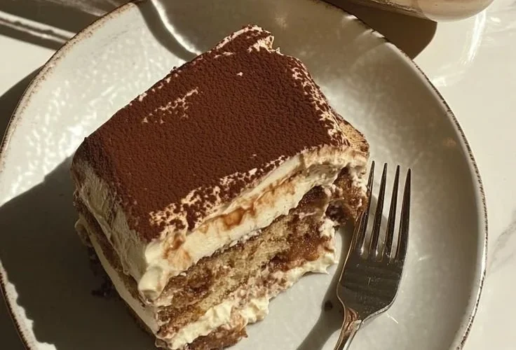 Protein-Packed Tiramisu topped with cocoa powder and coffee beans.