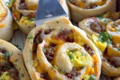 Delicious savory breakfast rolls ready to be served with a side of fresh fruit.
