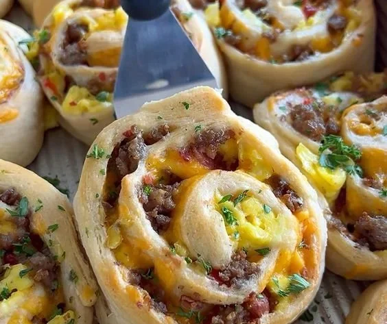 Delicious savory breakfast rolls ready to be served with a side of fresh fruit.