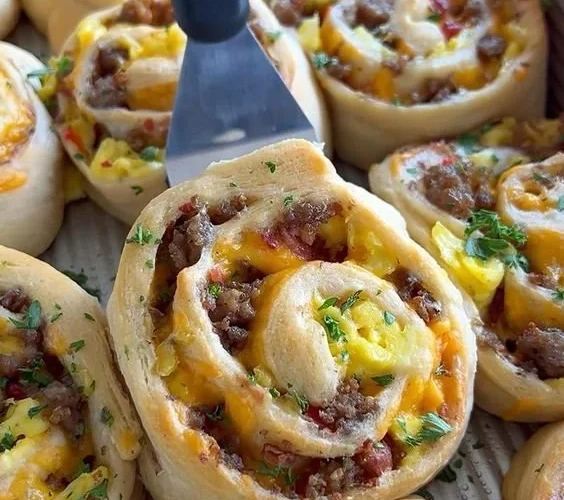 Delicious savory breakfast rolls ready to be served with a side of fresh fruit.