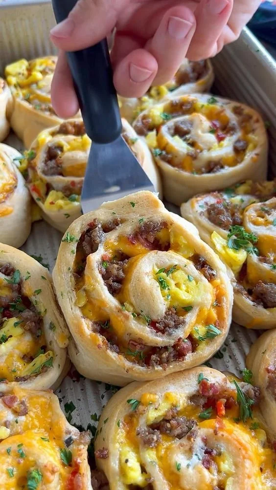 Delicious savory breakfast rolls ready to be served with a side of fresh fruit.