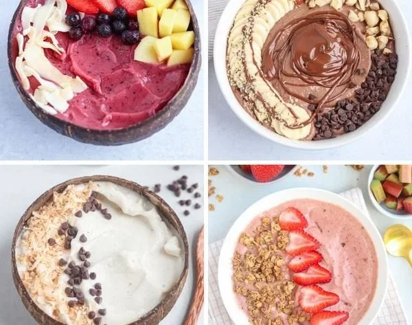 A colorful smoothie bowl topped with fresh fruits, nuts, and seeds