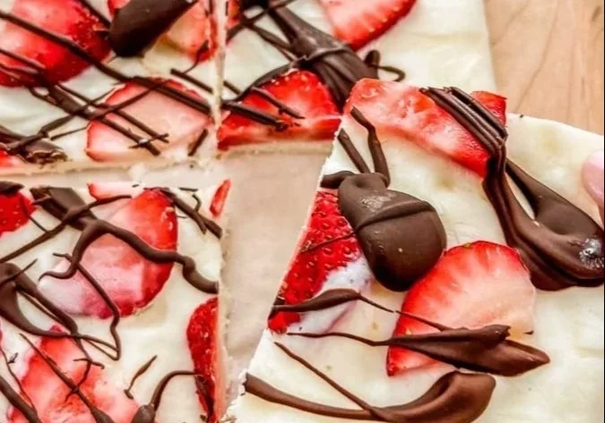 Homemade strawberry yogurt bark topped with fresh strawberries and nuts