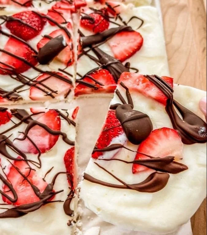 Homemade strawberry yogurt bark topped with fresh strawberries and nuts