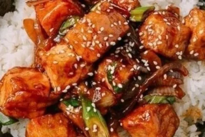 Vegan Teriyaki Tofu Rice Bowl garnished with vegetables and sesame seeds