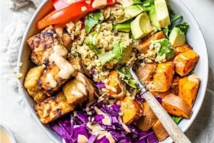 Vegan Thai tempeh Buddha bowl with colorful vegetables and grains.