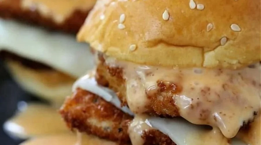 Bang Bang Chicken sliders served on a platter with spicy sauce