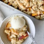 Easy almond flour peach cobbler topped with fresh peaches