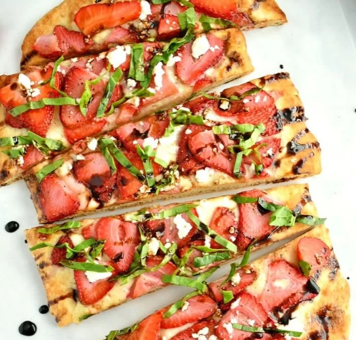 Balsamic strawberry flatbread garnished with fresh strawberries and balsamic glaze
