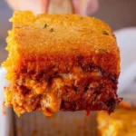 Delicious BBQ Chicken Cornbread Casserole topped with cheese and herbs
