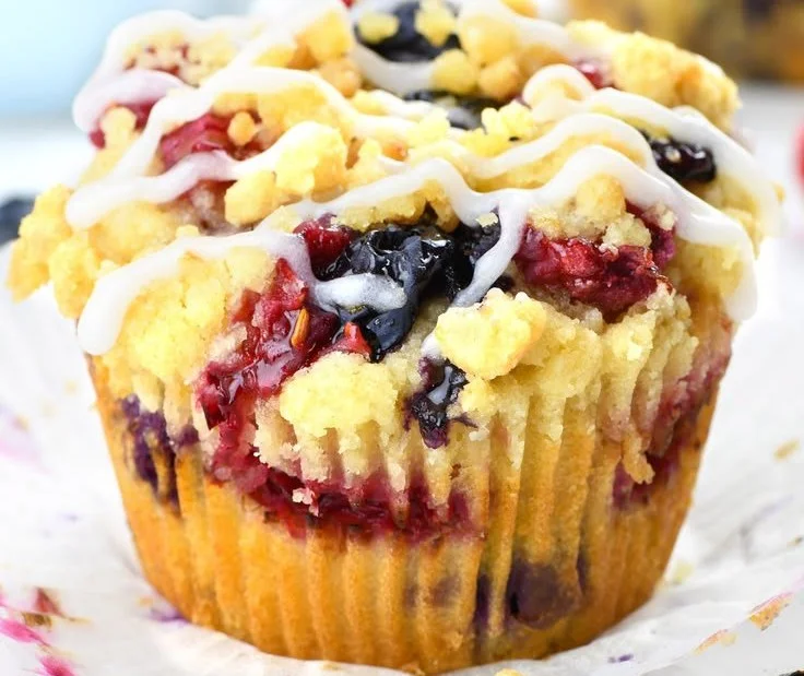 Freshly baked berry cream cheese muffins served on a plate