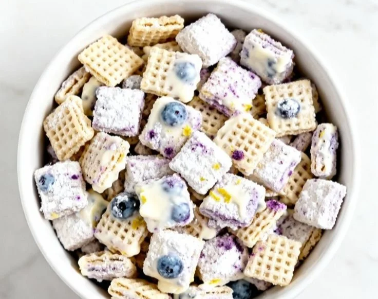 Blueberry lemon cheesecake puppy chow dessert treat in a bowl