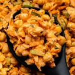 Buffalo Chickpea Salad in a bowl garnished with fresh herbs