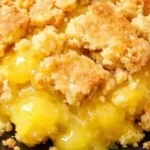 Buttery lemon dump cake slice on a plate