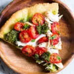 Delicious Chicken Pesto Pizza topped with fresh ingredients and pesto sauce