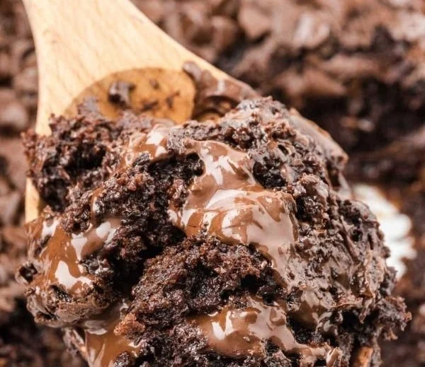 A decadent Chocolate Dump Cake topped with chocolate frosting and sprinkles