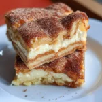 Delicious Churro Cheesecake Bars topped with cinnamon sugar
