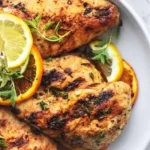 Citrus Dijon Grilled Chicken marinated and ready for grilling on a barbecue.