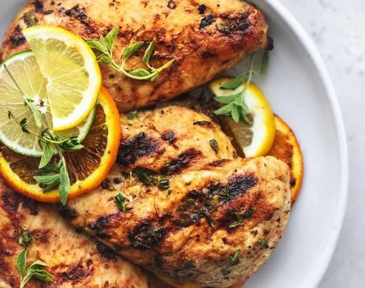 Citrus Dijon Grilled Chicken marinated and ready for grilling on a barbecue.