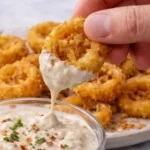 Crispy fried banana peppers served as a tasty appetizer or snack.