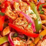 Easy Crockpot chicken fajitas with bell peppers and onions in a slow cooker