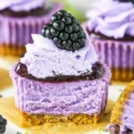 Mini blackberry lavender cheesecakes topped with fresh blackberries and lavender.
