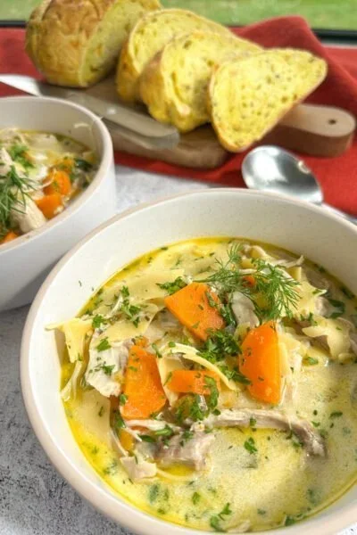 Easy Slow Cooker Tomato Chicken Curry served in a bowl with fresh herbs