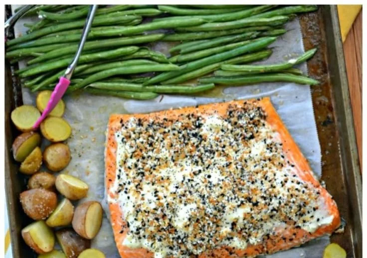 Sheet pan salmon seasoned with everything bagel spices on a baking sheet.