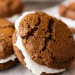Delicious gingerbread cookie sandwiches filled with tasty frosting