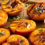 Delicious grilled peaches served with ice cream and drizzled with honey