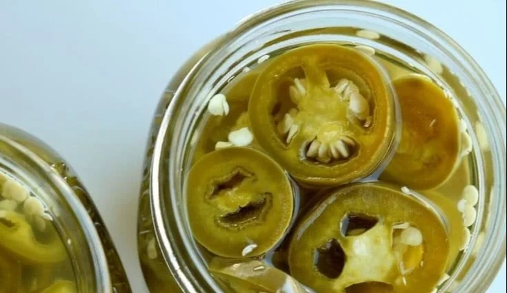 Homemade pickled jalapenos in a jar with spices