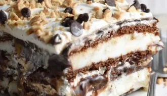 Delicious homemade Ice Cream Sandwich Cake topped with chocolate syrup and sprinkles