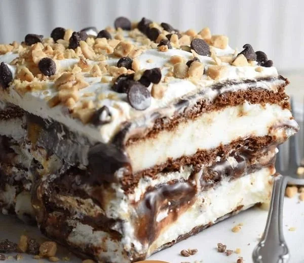 Delicious homemade Ice Cream Sandwich Cake topped with chocolate syrup and sprinkles
