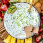 Delicious Key Lime Pie Fruit Dip served in a bowl with fresh lime garnishes