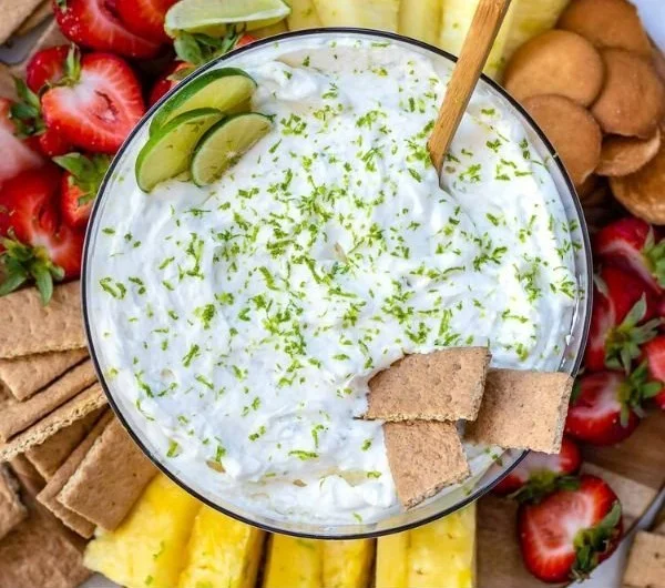 Delicious Key Lime Pie Fruit Dip served in a bowl with fresh lime garnishes